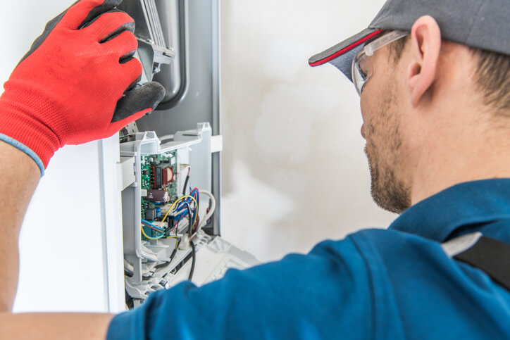 HVAC Specialist performing heating system maintenance