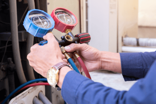 maintenance-background (1) hvac technician performing maintenance services on heating and cooling system with temperature gauges