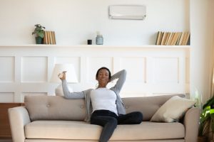 woman relaxes on couch in comfortable living room