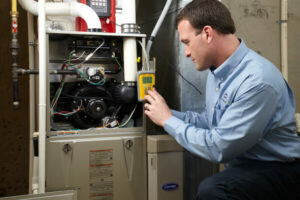 HVAC technician repairing furnace system