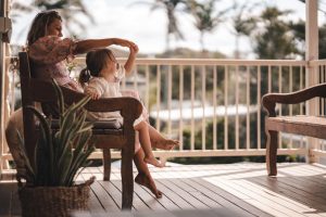 mother and child enjoying summer day on porch