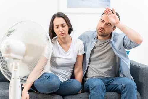 couple sweating inside their home