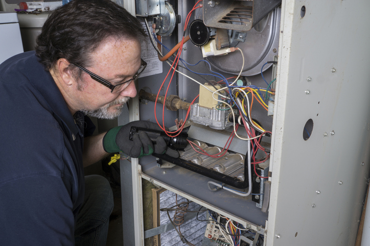 Technician servicing a furnace